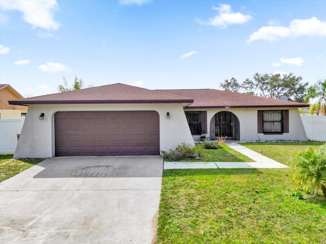 ranch-style home featuring a garage and a front lawn