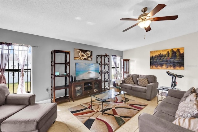 living room featuring plenty of natural light, a textured ceiling, and light tile patterned floors