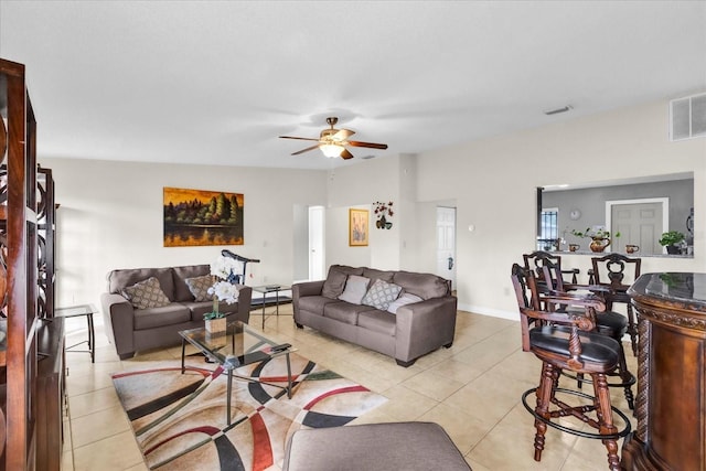 tiled living room with ceiling fan