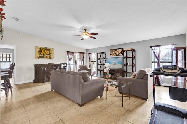 tiled living room with lofted ceiling, a wealth of natural light, and ceiling fan