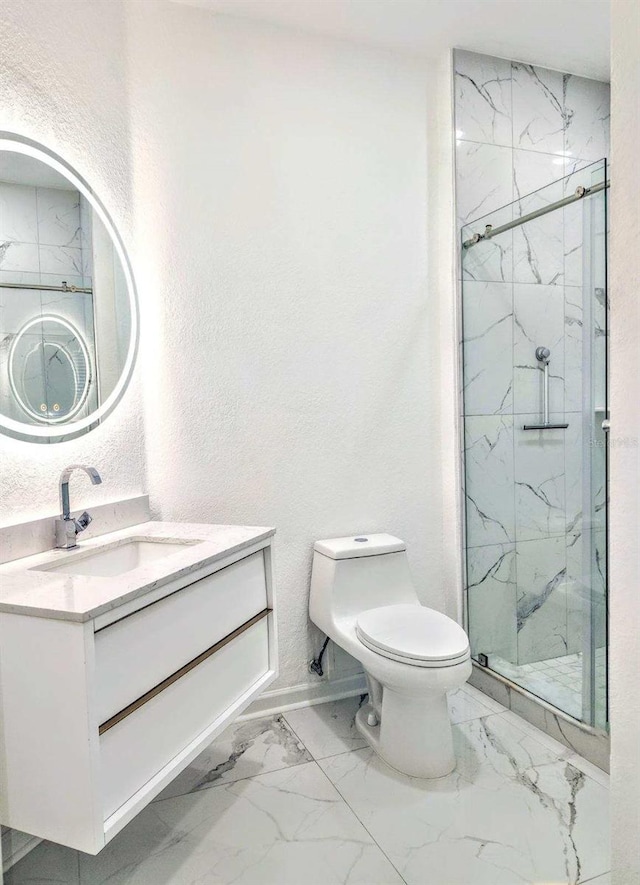 bathroom featuring a shower with shower door, vanity, and toilet