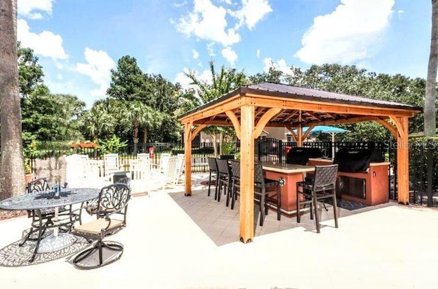 view of patio featuring a gazebo and exterior bar