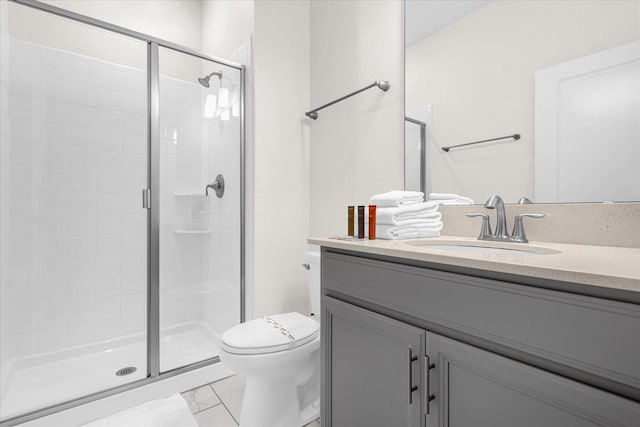 bathroom featuring toilet, an enclosed shower, and vanity