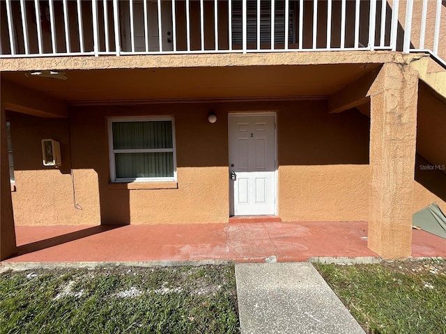 doorway to property with a balcony and a patio area