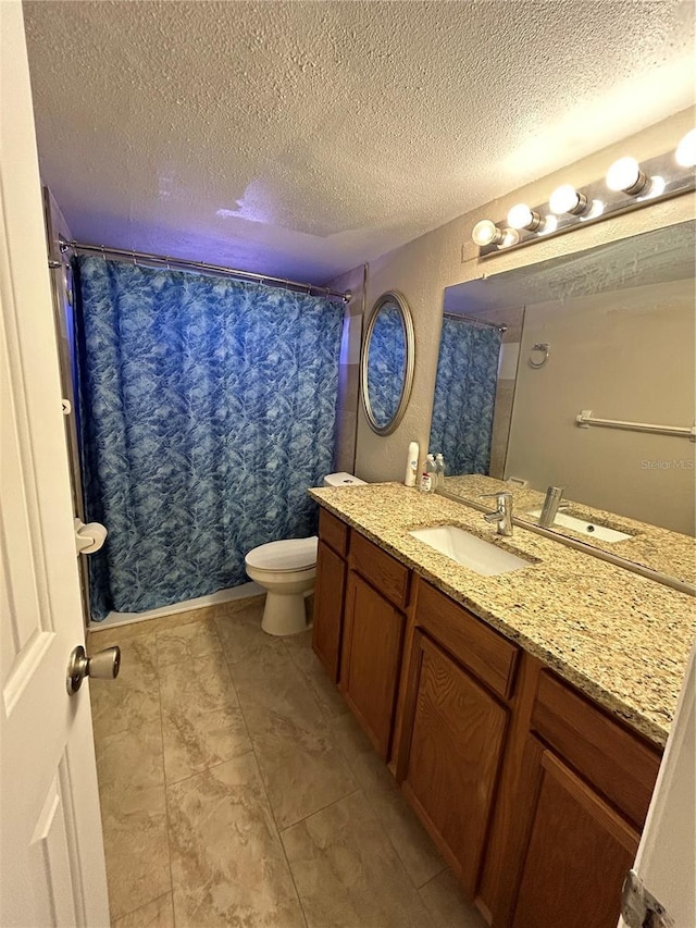 bathroom featuring toilet, a textured ceiling, walk in shower, and vanity