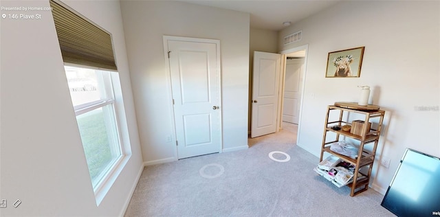 bedroom featuring light colored carpet