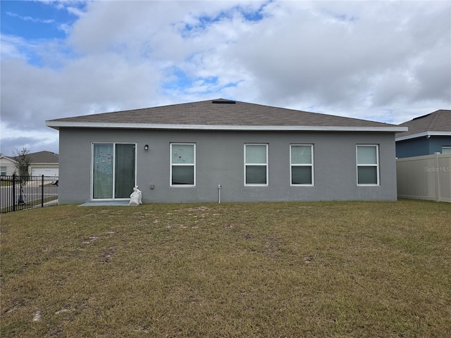 back of property featuring a lawn