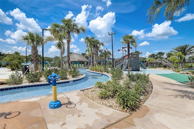 view of swimming pool featuring a playground