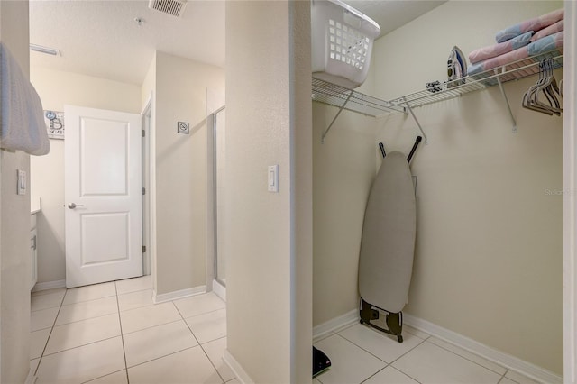 bathroom with an enclosed shower, tile patterned floors, and vanity