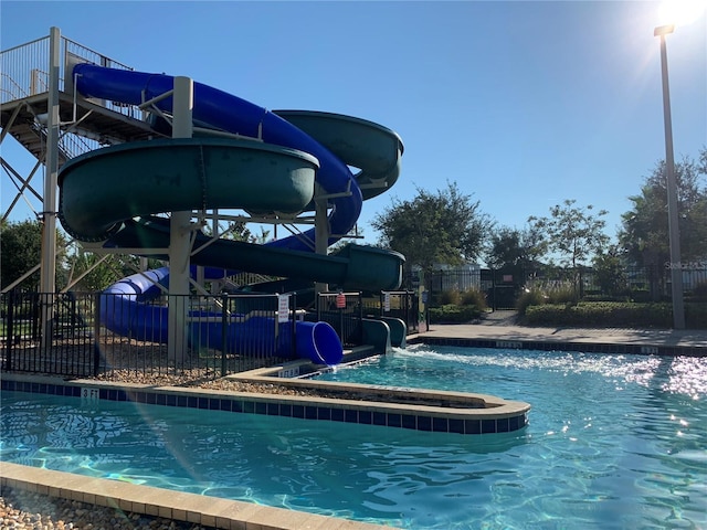 view of swimming pool featuring a water slide