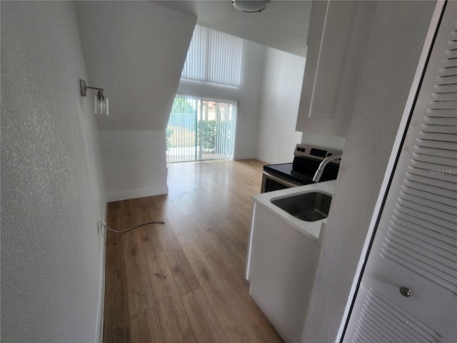 clothes washing area with light hardwood / wood-style floors