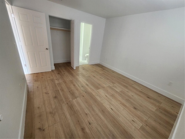 unfurnished bedroom featuring light wood-type flooring and a closet