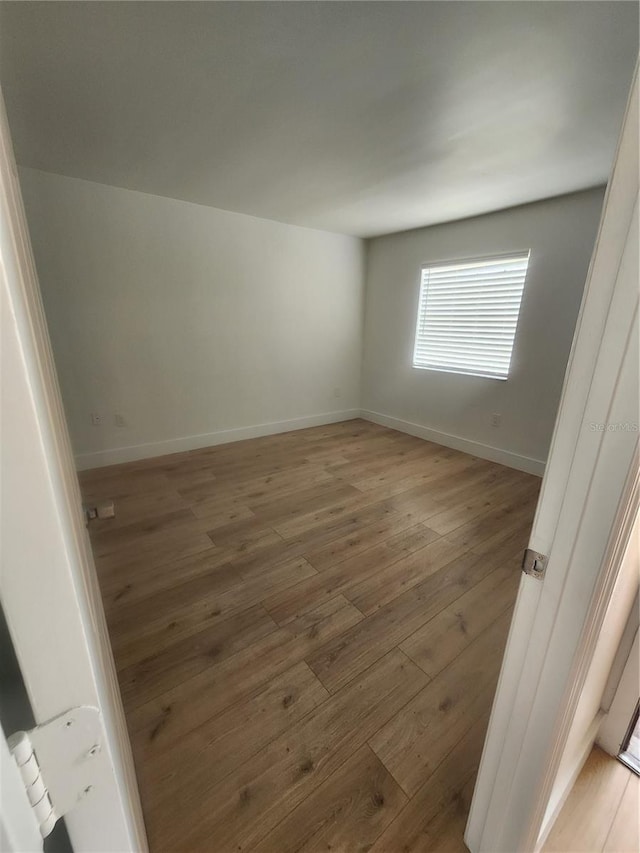 spare room with wood-type flooring