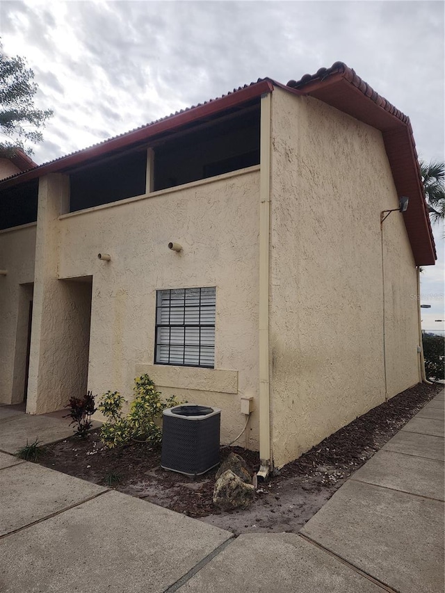 view of property exterior with central AC