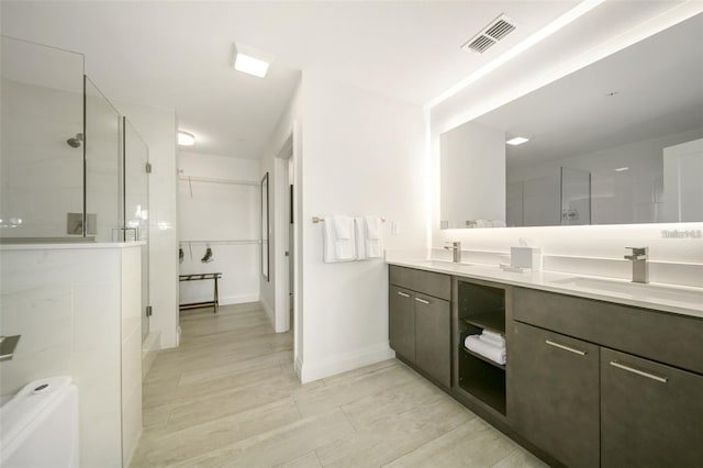 bathroom with walk in shower and vanity