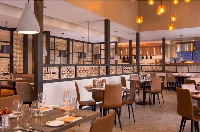 dining room featuring a towering ceiling