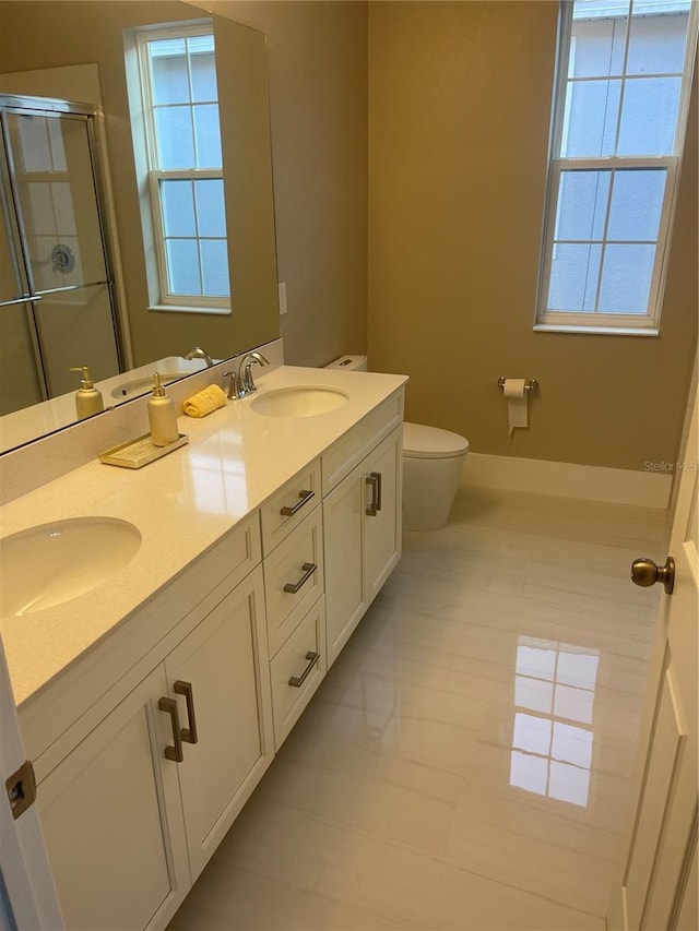 bathroom featuring tile patterned floors, an enclosed shower, vanity, and toilet