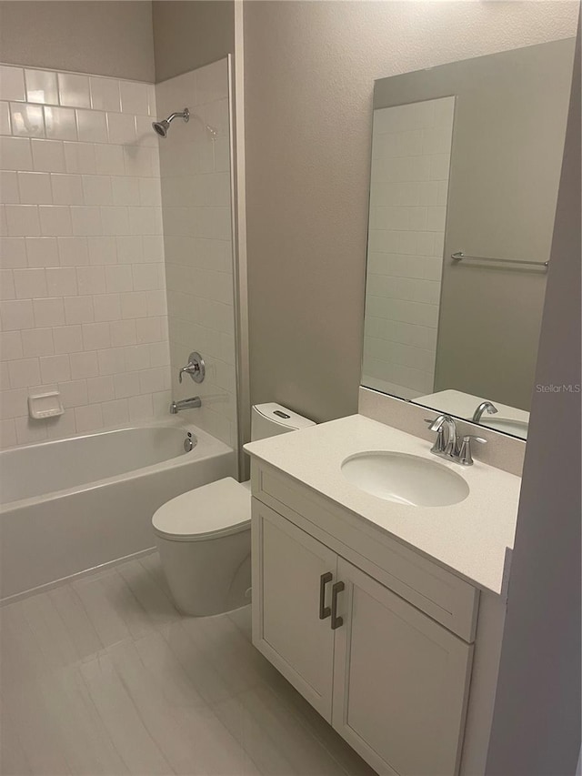 full bathroom featuring tile patterned floors, toilet, vanity, and tiled shower / bath