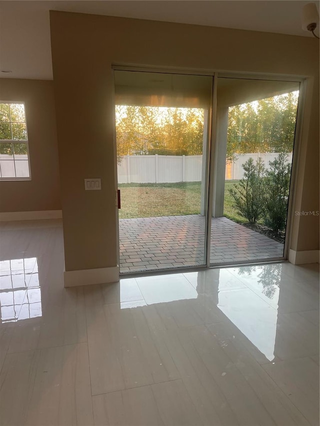 entryway featuring plenty of natural light and light tile patterned flooring