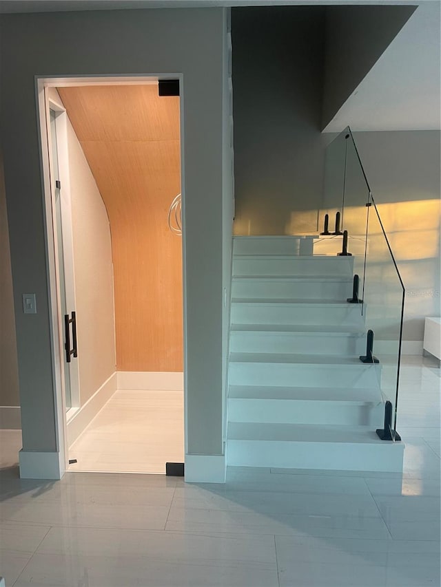 stairs featuring tile patterned floors