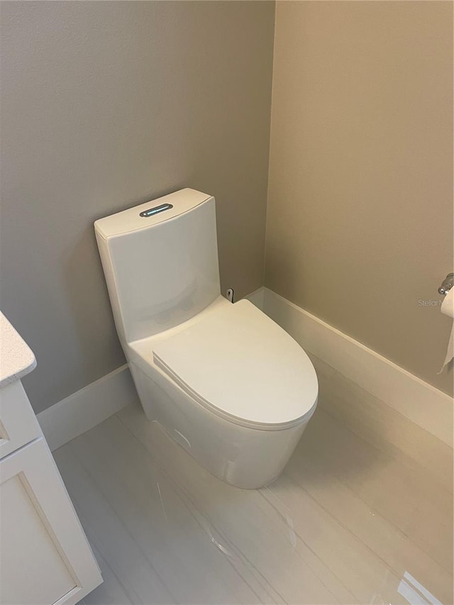 bathroom with tile patterned floors, toilet, and vanity