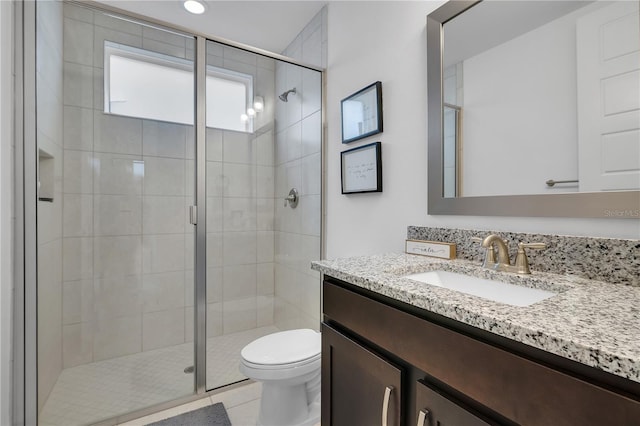 bathroom with toilet, tile patterned floors, walk in shower, and vanity