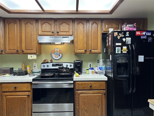 kitchen with stainless steel range with electric cooktop and black refrigerator with ice dispenser