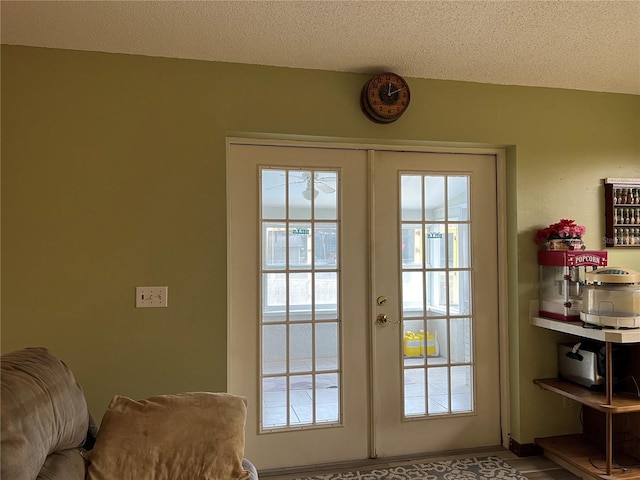 entryway featuring a textured ceiling and french doors