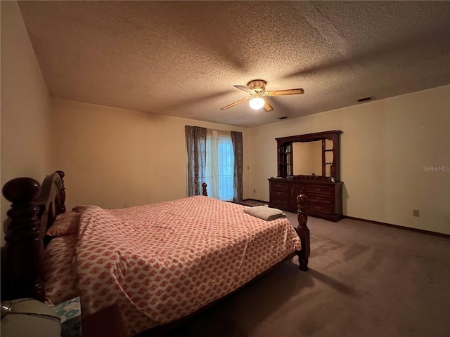 carpeted bedroom featuring a textured ceiling and ceiling fan