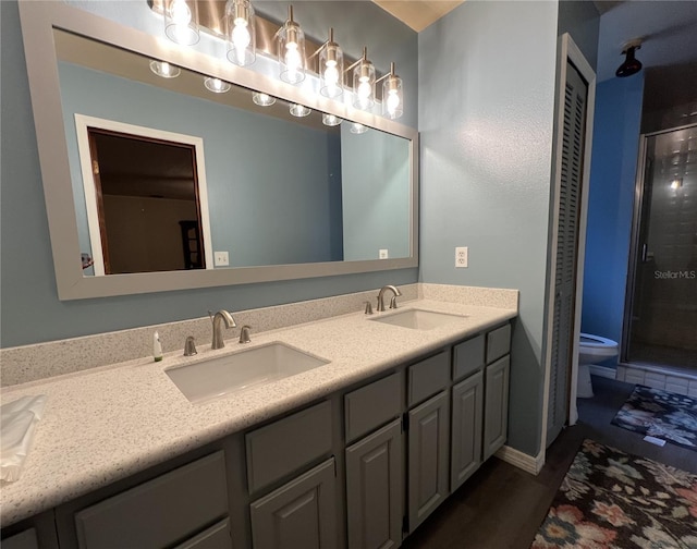 bathroom featuring toilet, an enclosed shower, and vanity