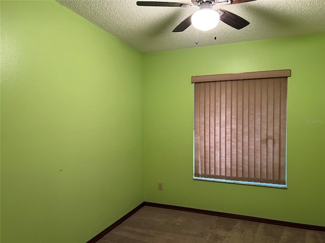 spare room with a textured ceiling, ceiling fan, and carpet