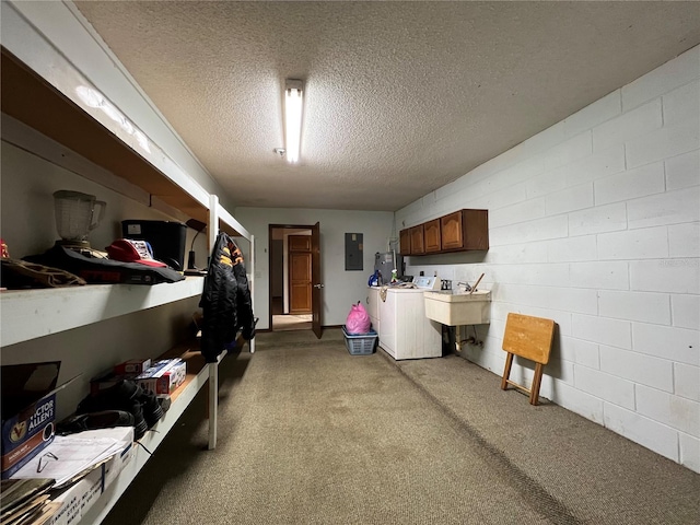 laundry room with sink, a textured ceiling, electric panel, cabinets, and separate washer and dryer