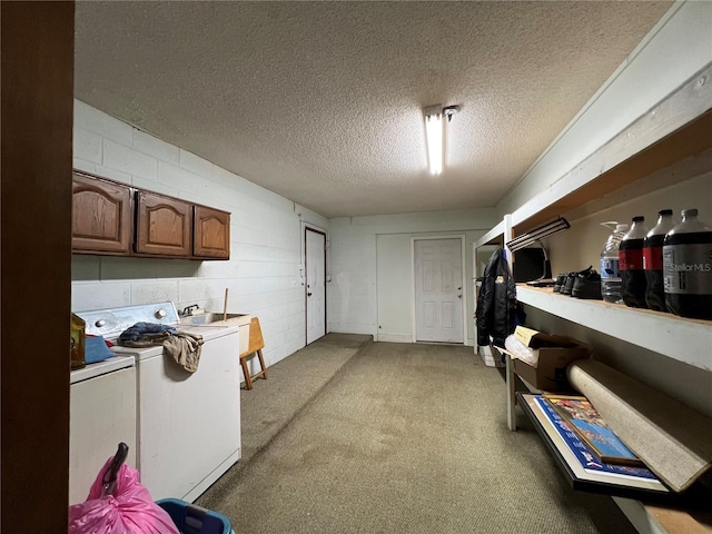 interior space featuring washer / dryer, a textured ceiling, and sink