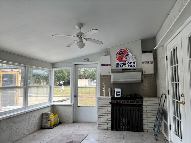 sunroom / solarium with lofted ceiling and ceiling fan