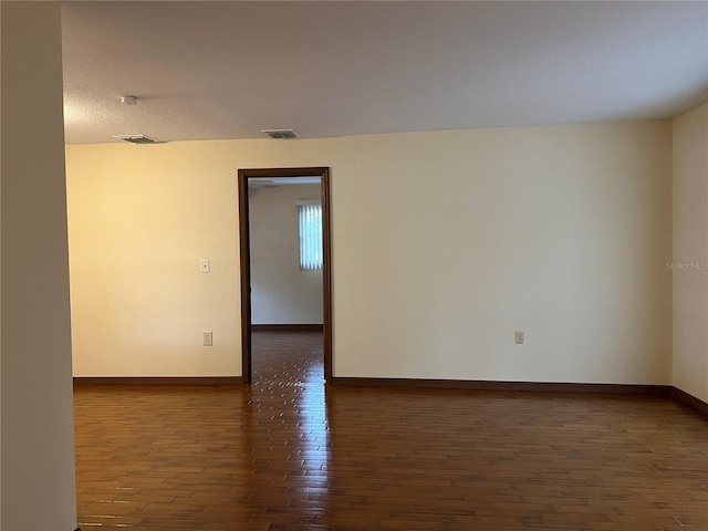 empty room featuring dark wood-type flooring