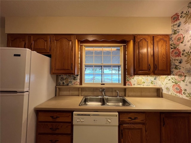 kitchen featuring sink and white appliances