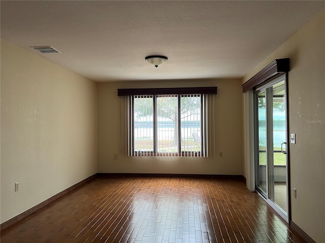 unfurnished room featuring hardwood / wood-style flooring