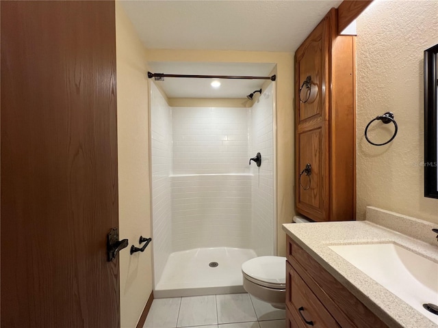 bathroom with toilet, tile patterned floors, walk in shower, and vanity