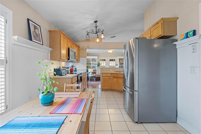 kitchen featuring pendant lighting, light brown cabinets, stainless steel appliances, and light tile patterned flooring