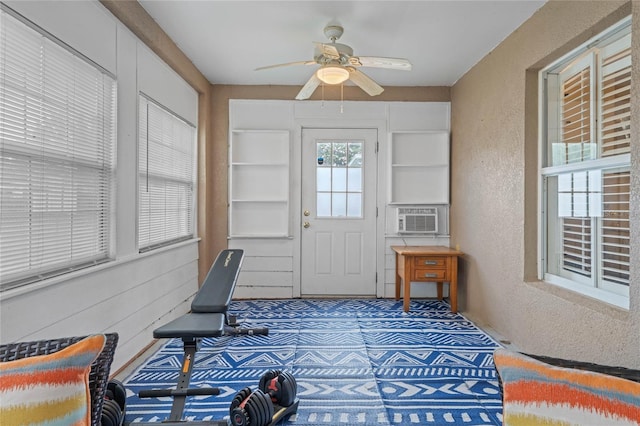 sunroom / solarium featuring cooling unit and ceiling fan