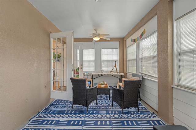 sunroom / solarium featuring ceiling fan and plenty of natural light