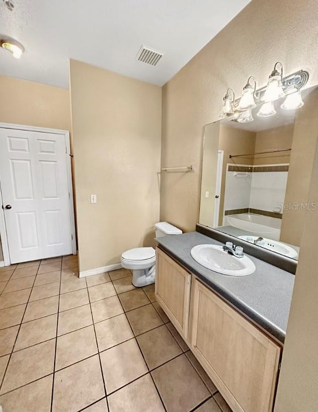 bathroom featuring toilet, vanity, and tile patterned floors