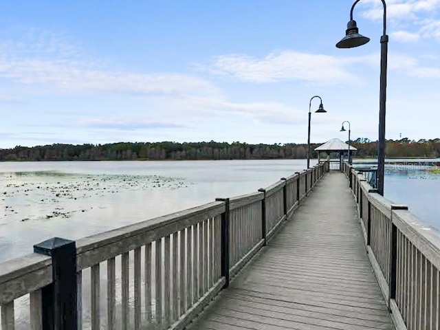 view of dock with a water view and a gazebo