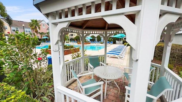 exterior space featuring a community pool and a gazebo