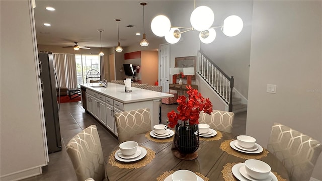 tiled dining area with sink and ceiling fan