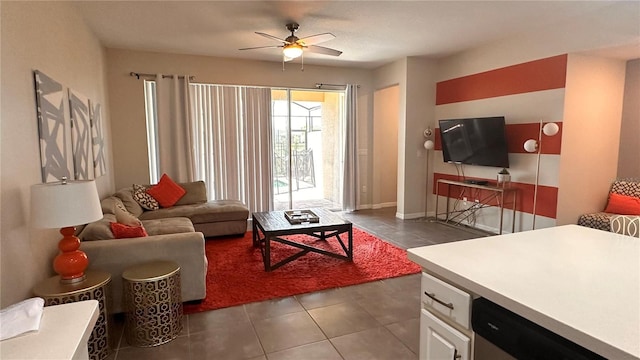 living room featuring dark tile patterned floors and ceiling fan