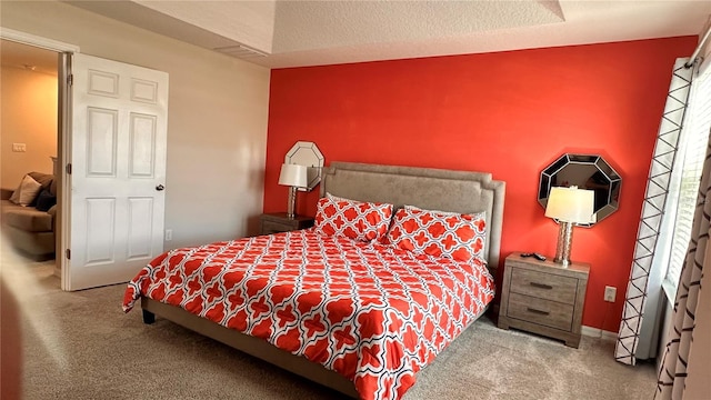 bedroom with a textured ceiling and carpet floors