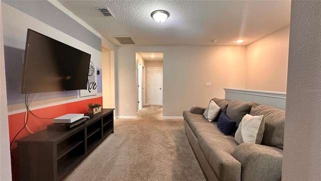 carpeted living room featuring a textured ceiling