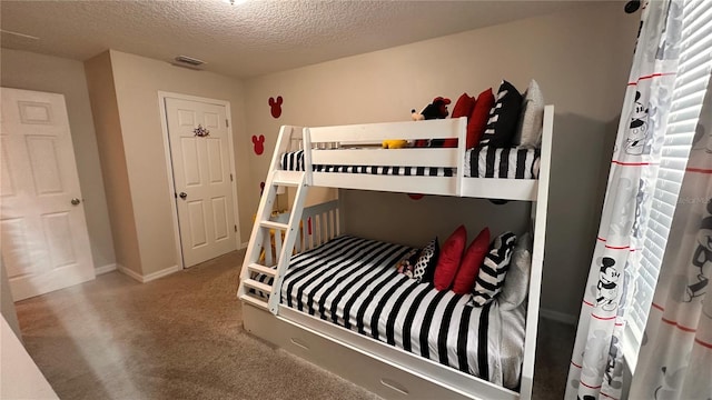 carpeted bedroom with a textured ceiling