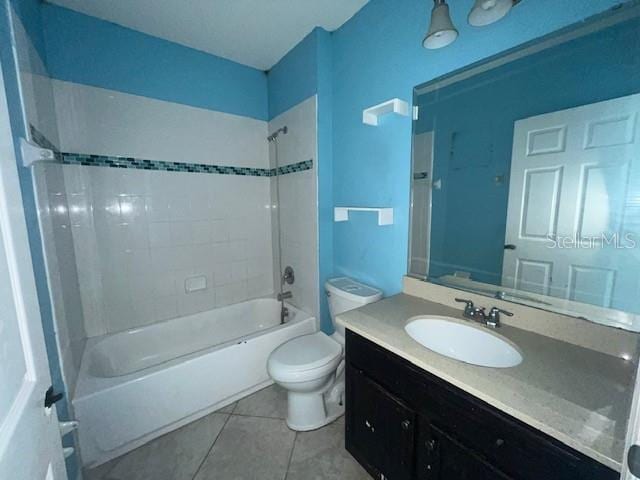 full bathroom featuring toilet, tile patterned floors, vanity, and tiled shower / bath